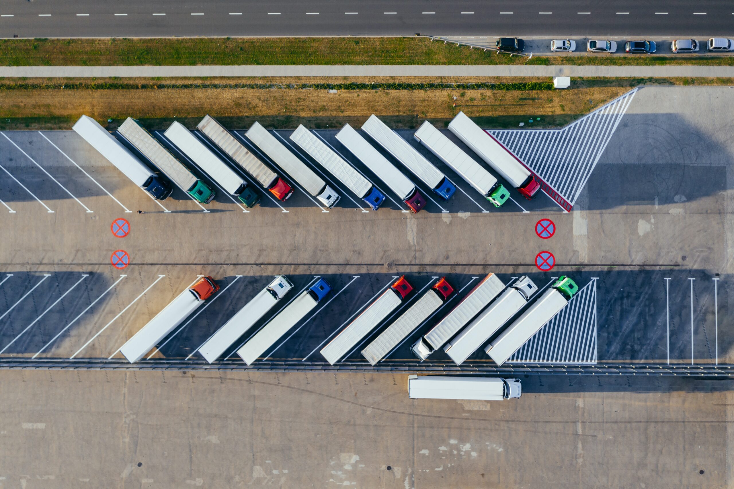 Birdseye view of  large arctic trucks parked diagonally opposite each other