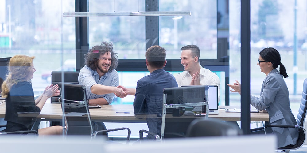 Business people sitting around a table talking