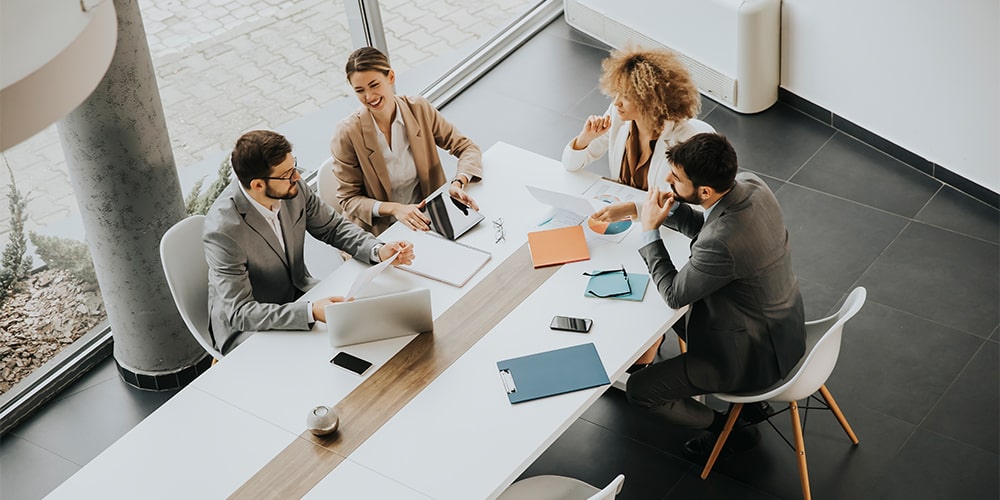 Business people sitting around a table talking
