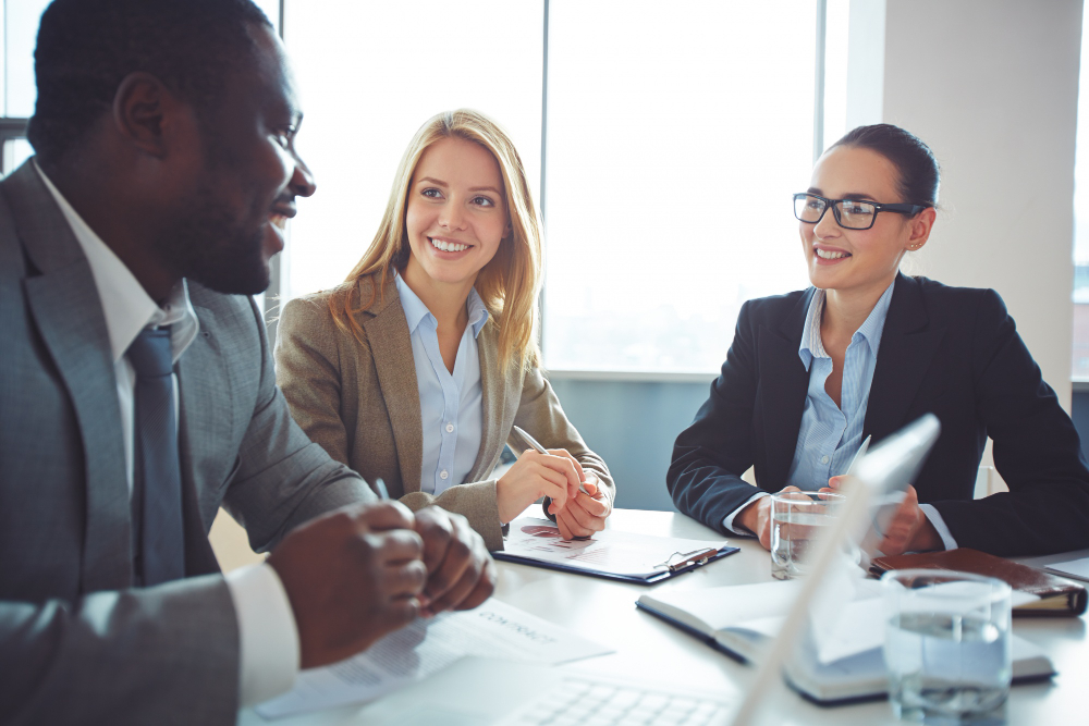 Business people sitting around a table talking