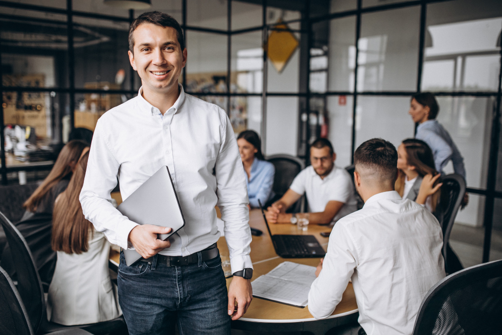 Programme manager standing in front of a desk of Project Managers 